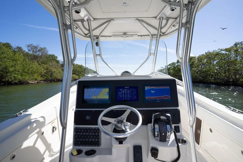 Trident Yacht Photos Pics 2007 Hydra-Sports Vector 3300 CC boat console with navigation screens and steering wheel.