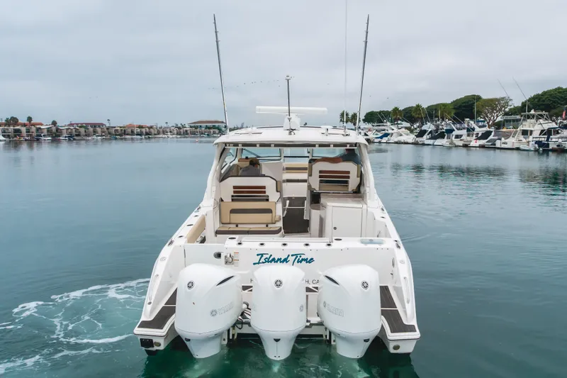  Yacht Photos Pics 2018 Pursuit boat "Island Time" with dual Yamaha engines in a marina setting.