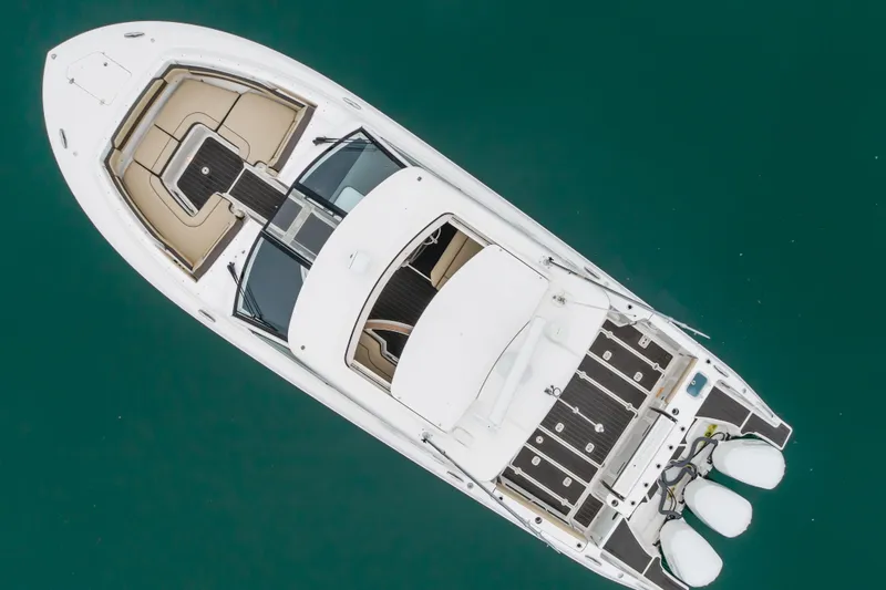  Yacht Photos Pics Aerial view of 2018 Pursuit boat on turquoise water.