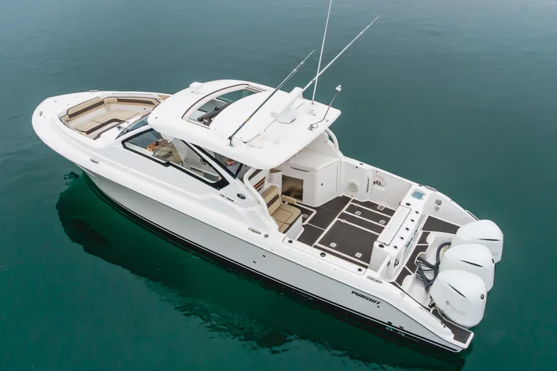  Yacht Photos Pics 2018 Pursuit boat with triple outboard engines on calm water.