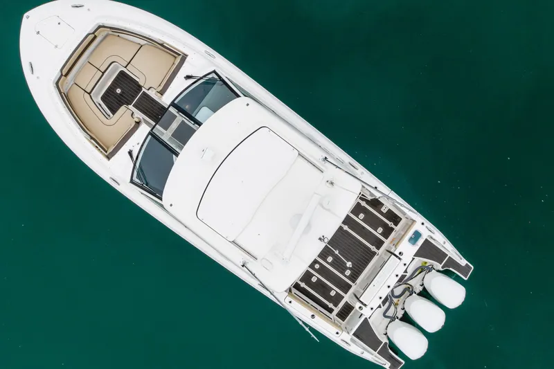  Yacht Photos Pics Aerial view of 2018 Pursuit boat on clear turquoise water.