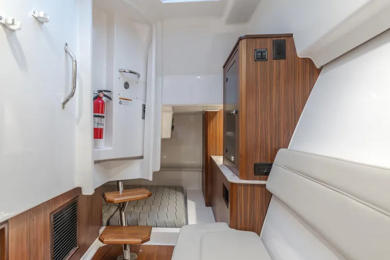  Yacht Photos Pics Interior of a 2018 Pursuit boat featuring wood accents and seating area.