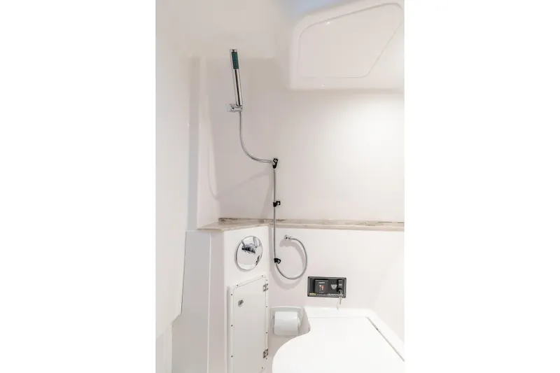  Yacht Photos Pics Compact 2018 Pursuit boat bathroom with showerhead and modern fixtures.