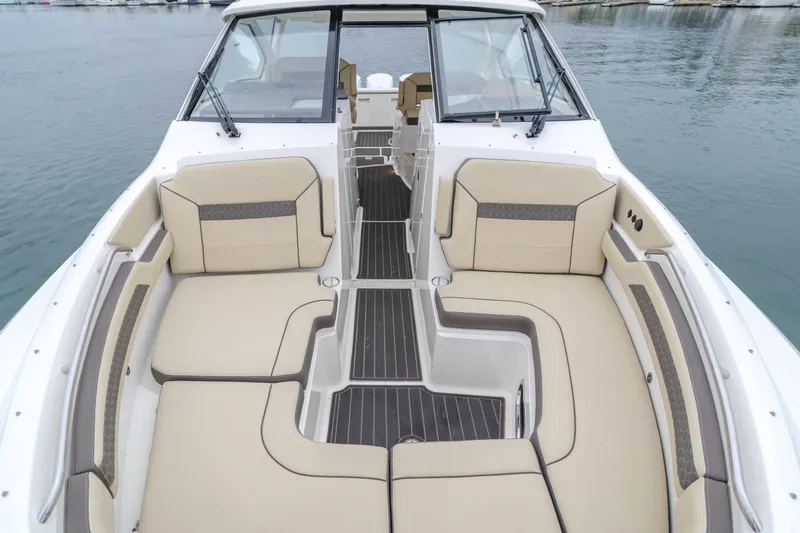  Yacht Photos Pics 2018 Pursuit boat with spacious seating and sleek design on calm water.