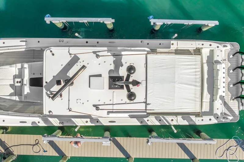 Best Deal Yacht Photos Pics Aerial view of 2023 HCB 53 Suenos RXV yacht docked in turquoise water.