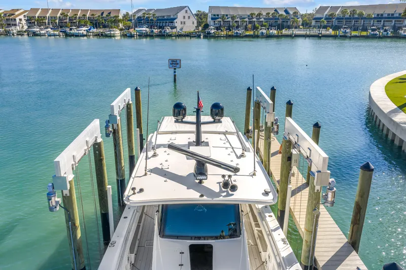Best Deal Yacht Photos Pics 2023 HCB 53 Suenos RXV docked in a serene marina setting.
