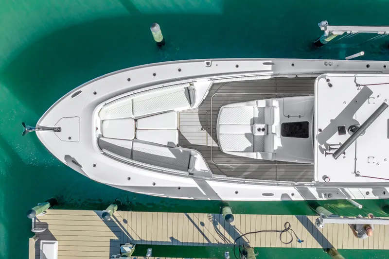 Best Deal Yacht Photos Pics Aerial view of 2023 HCB 53 Suenos RXV yacht docked in turquoise water.