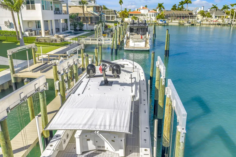Best Deal Yacht Photos Pics 2023 HCB 53 Suenos RXV docked in a scenic waterfront marina.