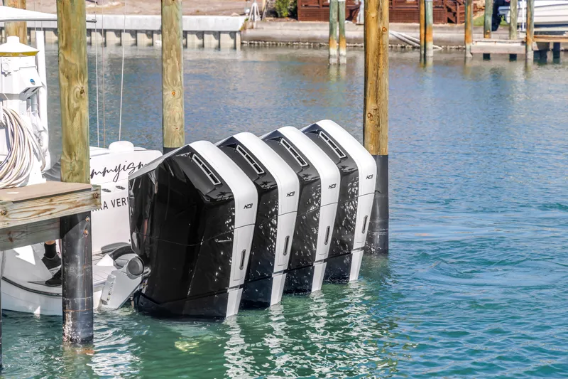 Best Deal Yacht Photos Pics 2023 HCB 53 Suenos RXV with four powerful outboard engines docked in marina.