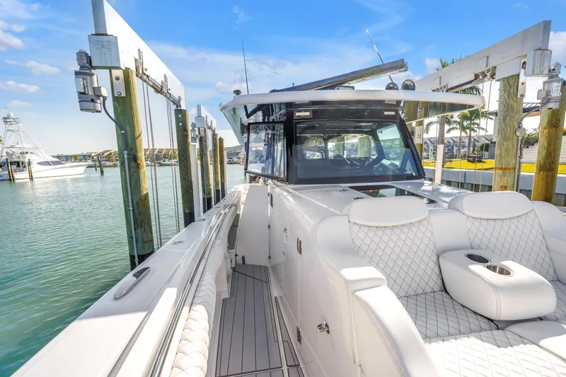 Best Deal Yacht Photos Pics 2023 HCB 53 Suenos RXV luxury boat docked at marina, featuring plush seating.