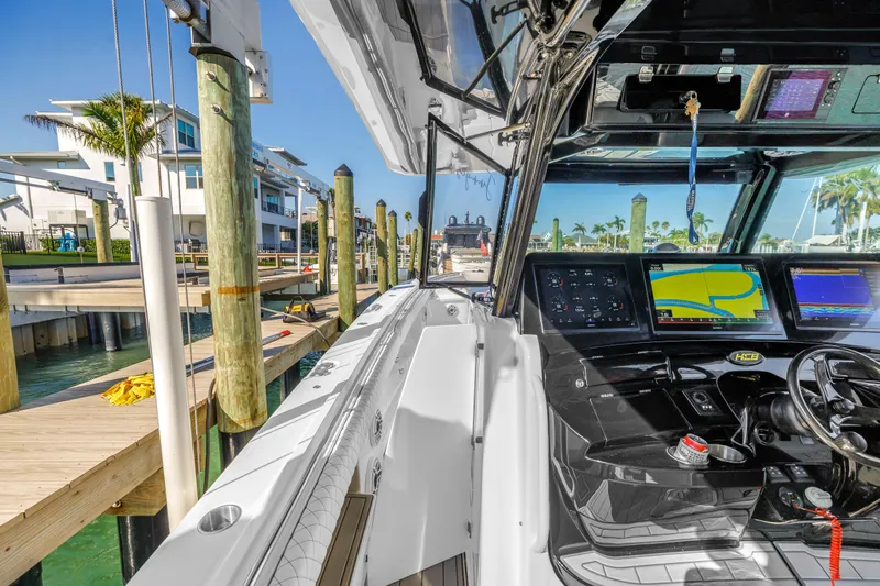 Best Deal Yacht Photos Pics 2023 HCB 53 Suenos RXV boat interior with advanced navigation system at a marina.