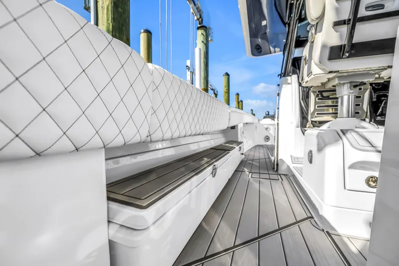 Best Deal Yacht Photos Pics 2023 HCB 53 Suenos RXV boat interior with cushioned seating and sleek design.