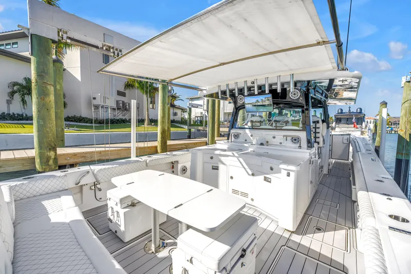 Best Deal Yacht Photos Pics 2023 HCB 53 Suenos RXV luxury boat interior with seating and table, docked at marina.