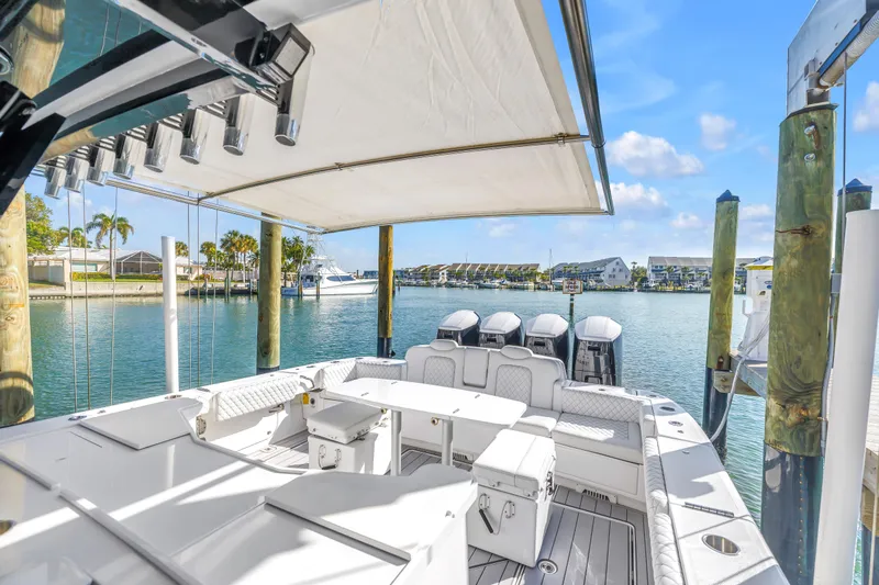 Best Deal Yacht Photos Pics 2023 HCB 53 Suenos RXV luxury boat docked in a sunny marina setting.