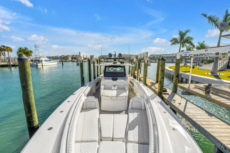 Best Deal Yacht Photos Pics 2023 HCB 53 Suenos RXV luxury boat docked in a sunny marina setting.