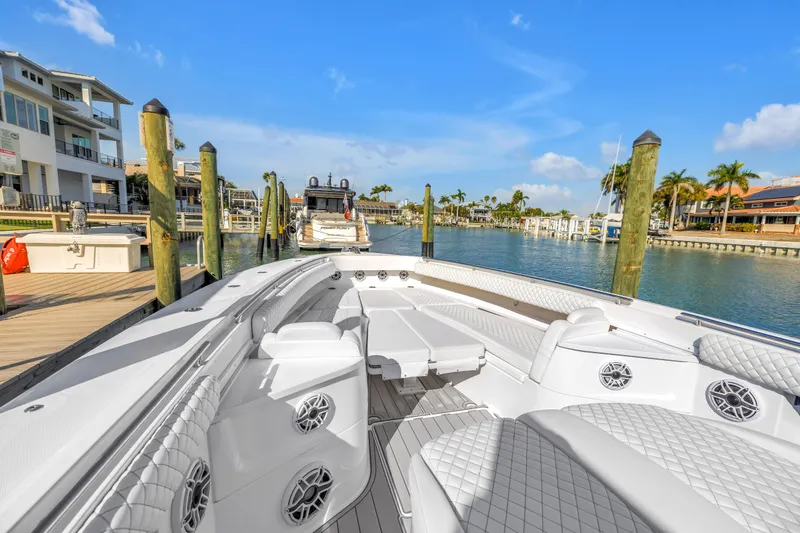 Best Deal Yacht Photos Pics 2023 HCB 53 Suenos RXV luxury boat docked in sunny marina.