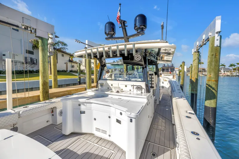 Best Deal Yacht Photos Pics 2023 HCB 53 Suenos RXV luxury boat docked at marina under clear blue sky.