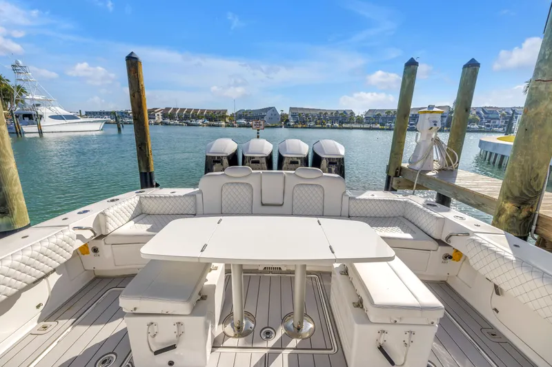 Best Deal Yacht Photos Pics 2023 HCB 53 Suenos RXV boat interior with seating and table, docked in marina.