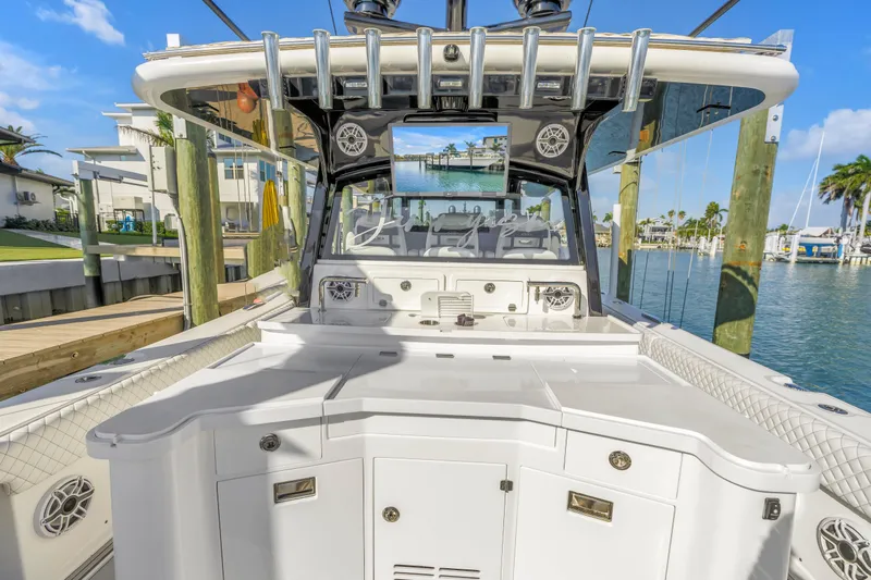 Best Deal Yacht Photos Pics 2023 HCB 53 Suenos RXV luxury boat docked in a marina, showcasing sleek design.