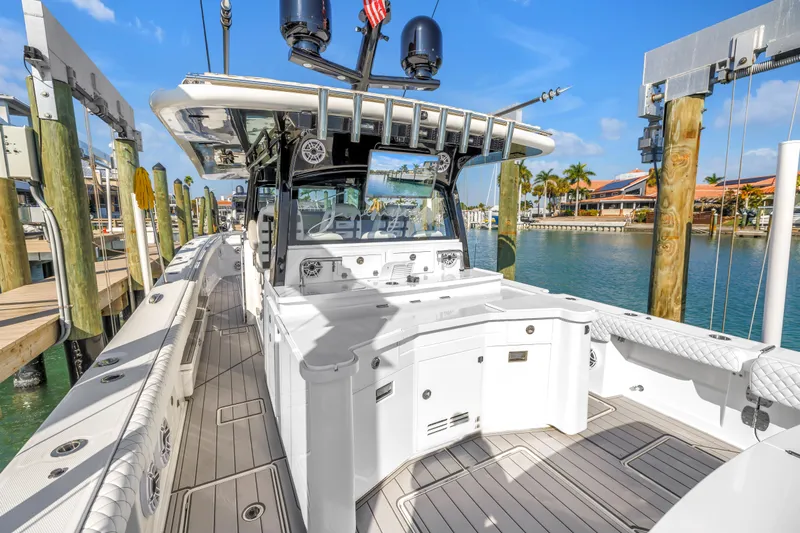 Best Deal Yacht Photos Pics 2023 HCB 53 Suenos RXV luxury boat docked at marina under clear blue sky.