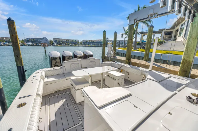 Best Deal Yacht Photos Pics 2023 HCB 53 Suenos RXV luxury boat docked at marina, featuring spacious seating and multiple engines.