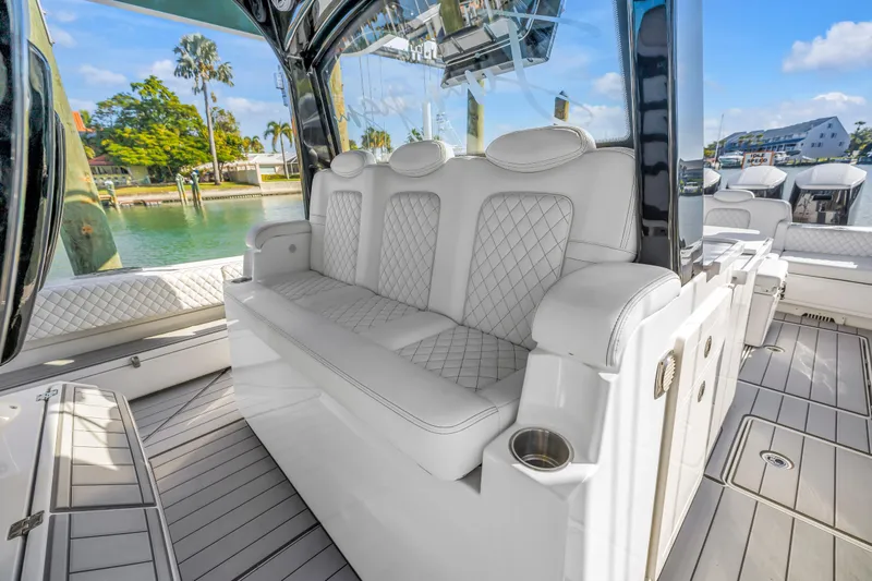 Best Deal Yacht Photos Pics Luxurious seating on 2023 HCB 53 Suenos RXV boat, featuring elegant white upholstery.