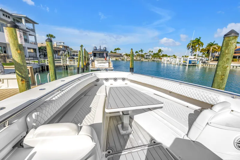 Best Deal Yacht Photos Pics 2023 HCB 53 Suenos RXV luxury boat docked in a sunny marina setting.