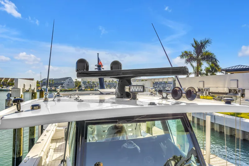 Best Deal Yacht Photos Pics 2023 HCB 53 Suenos RXV yacht docked, showcasing advanced navigation equipment under clear blue skies.