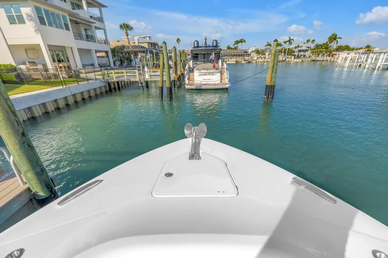 Best Deal Yacht Photos Pics Bow view of 2023 HCB 53 Suenos RXV docked in a sunny marina.