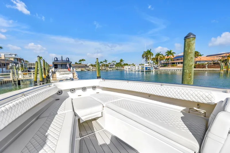 Best Deal Yacht Photos Pics 2023 HCB 53 Suenos RXV luxury boat interior at marina with palm trees.