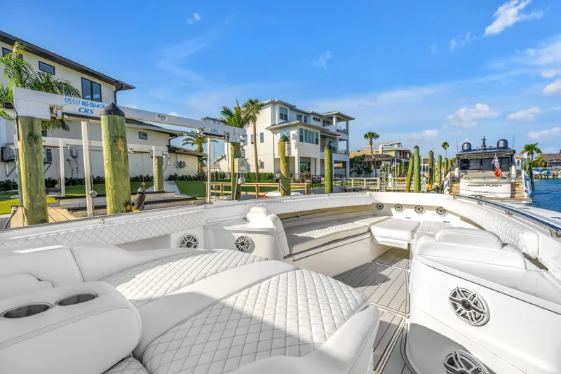 Best Deal Yacht Photos Pics Luxurious 2023 HCB 53 Suenos RXV boat docked at a marina with modern waterfront homes.