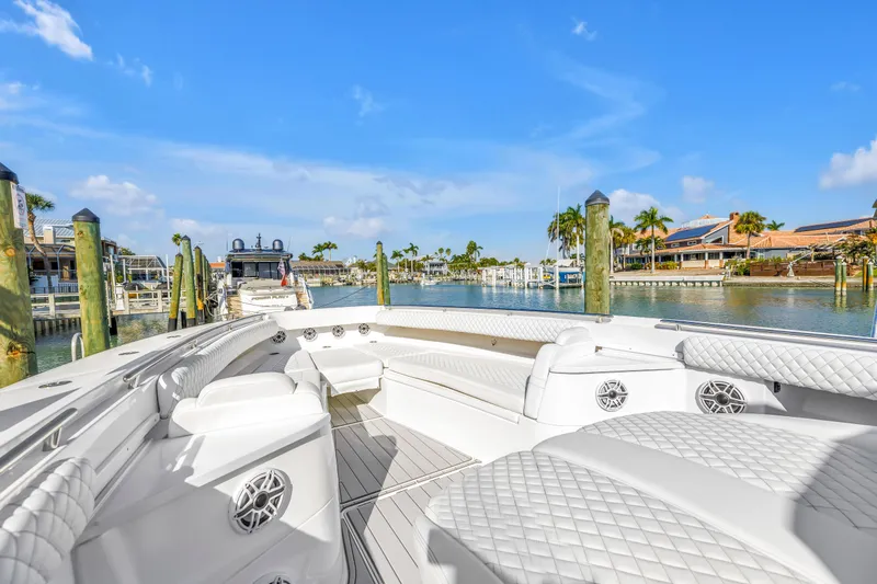 Best Deal Yacht Photos Pics 2023 HCB 53 Suenos RXV luxury boat docked in a sunny marina setting.