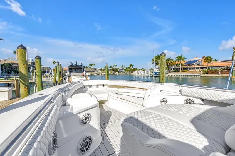 Best Deal Yacht Photos Pics 2023 HCB 53 Suenos RXV luxury boat docked in sunny marina setting.