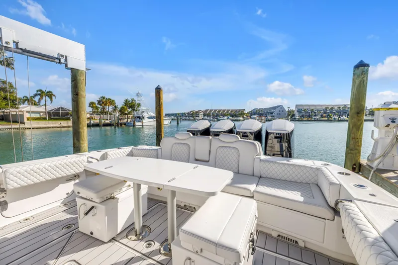 Best Deal Yacht Photos Pics 2023 HCB 53 Suenos RXV luxury boat docked with elegant seating and scenic waterfront view.