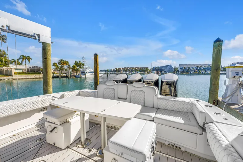 Best Deal Yacht Photos Pics 2023 HCB 53 Suenos RXV luxury boat interior with seating and table, docked in a marina.