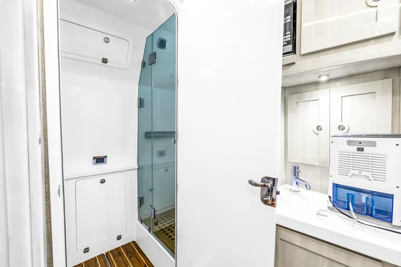 Best Deal Yacht Photos Pics Luxurious bathroom interior of 2023 HCB 53 Suenos RXV yacht with modern shower and cabinetry.