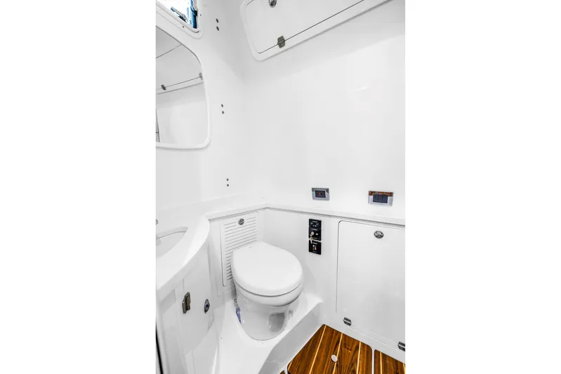 Best Deal Yacht Photos Pics Luxurious bathroom in 2023 HCB 53 Suenos RXV boat with modern fixtures and wooden flooring.