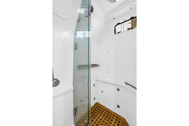 Best Deal Yacht Photos Pics 2023 HCB 53 Suenos RXV boat shower with glass door and wooden floor.