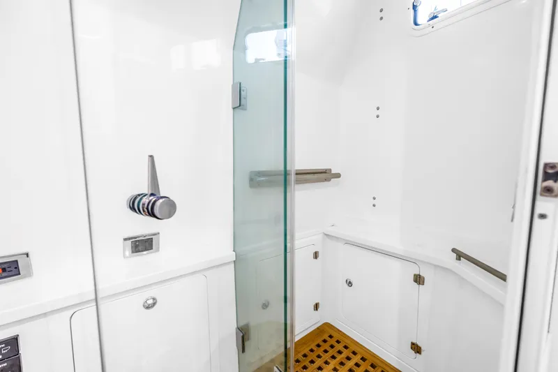 Best Deal Yacht Photos Pics 2023 HCB 53 Suenos RXV yacht bathroom with glass shower and wooden floor.