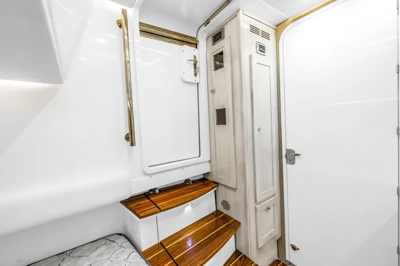 Best Deal Yacht Photos Pics Interior of 2023 HCB 53 Suenos RXV yacht with wooden steps and white cabinetry.
