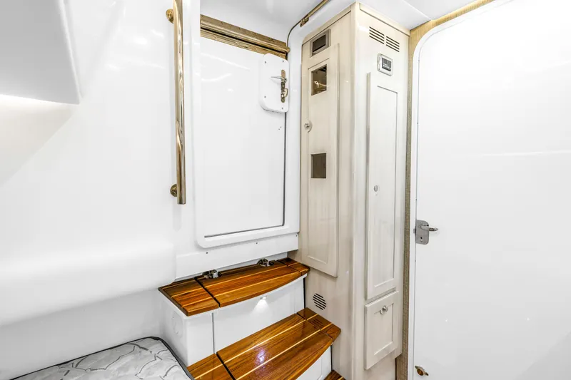 Best Deal Yacht Photos Pics 2023 HCB 53 Suenos RXV interior with wooden steps and white cabinetry.