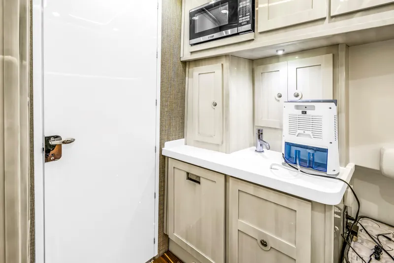 Best Deal Yacht Photos Pics 2023 HCB 53 Suenos RXV interior with kitchenette, microwave, and water purifier.