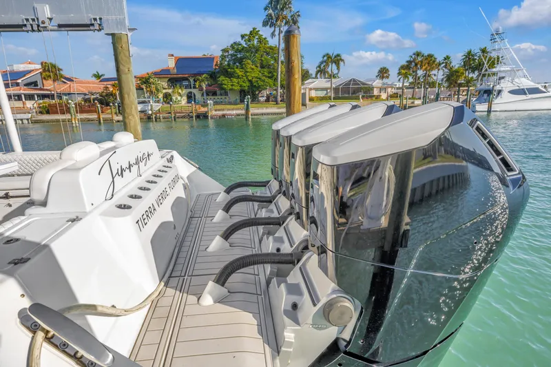 Best Deal Yacht Photos Pics 2023 HCB 53 Suenos RXV boat with powerful outboard engines docked in sunny marina.