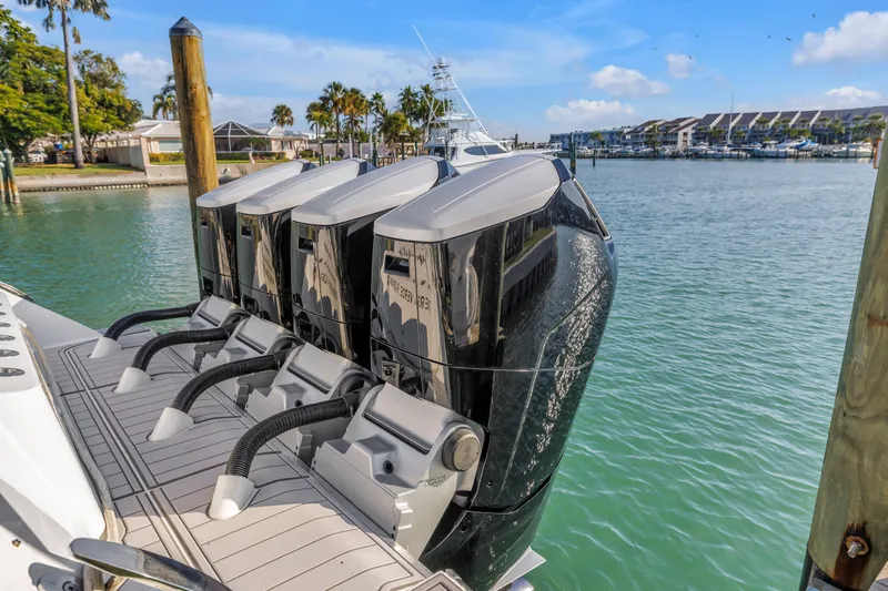 Best Deal Yacht Photos Pics 2023 HCB 53 Suenos RXV boat with four powerful outboard engines docked in marina.