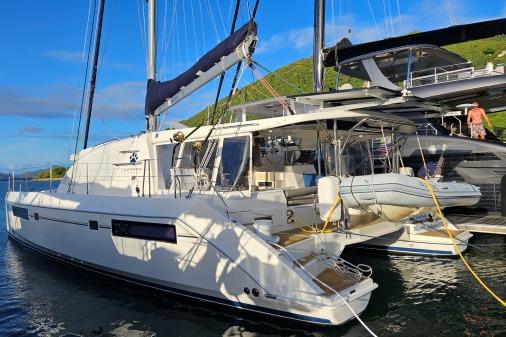 2015 Leopard 48 catamaran docked in a scenic marina, featuring modern design and spacious deck.