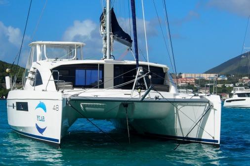 2015 Robertson & Caine Leopard 48 catamaran sailing in clear blue waters.