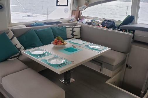 Interior of 2015 Robertson & Caine Leopard 48 yacht with dining area set for four.