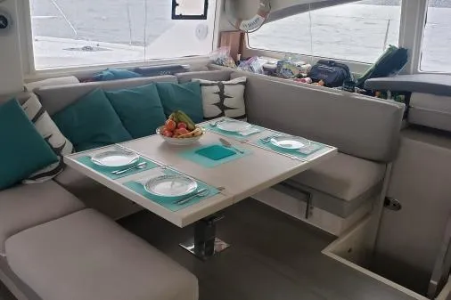 Pilar Yacht Photos Pics Interior of 2015 Robertson & Caine Leopard 48 yacht with dining area set for four.