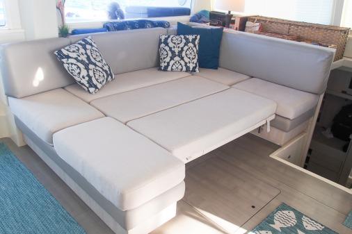 2015 Robertson & Caine Leopard 48 yacht interior with modern gray seating and decorative pillows.