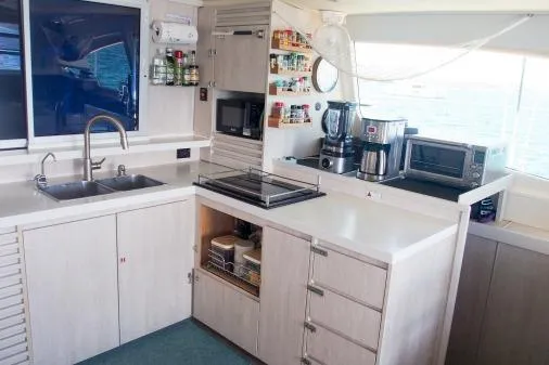 Pilar Yacht Photos Pics Modern kitchen in a 2015 Robertson & Caine Leopard 48 yacht with appliances and storage.